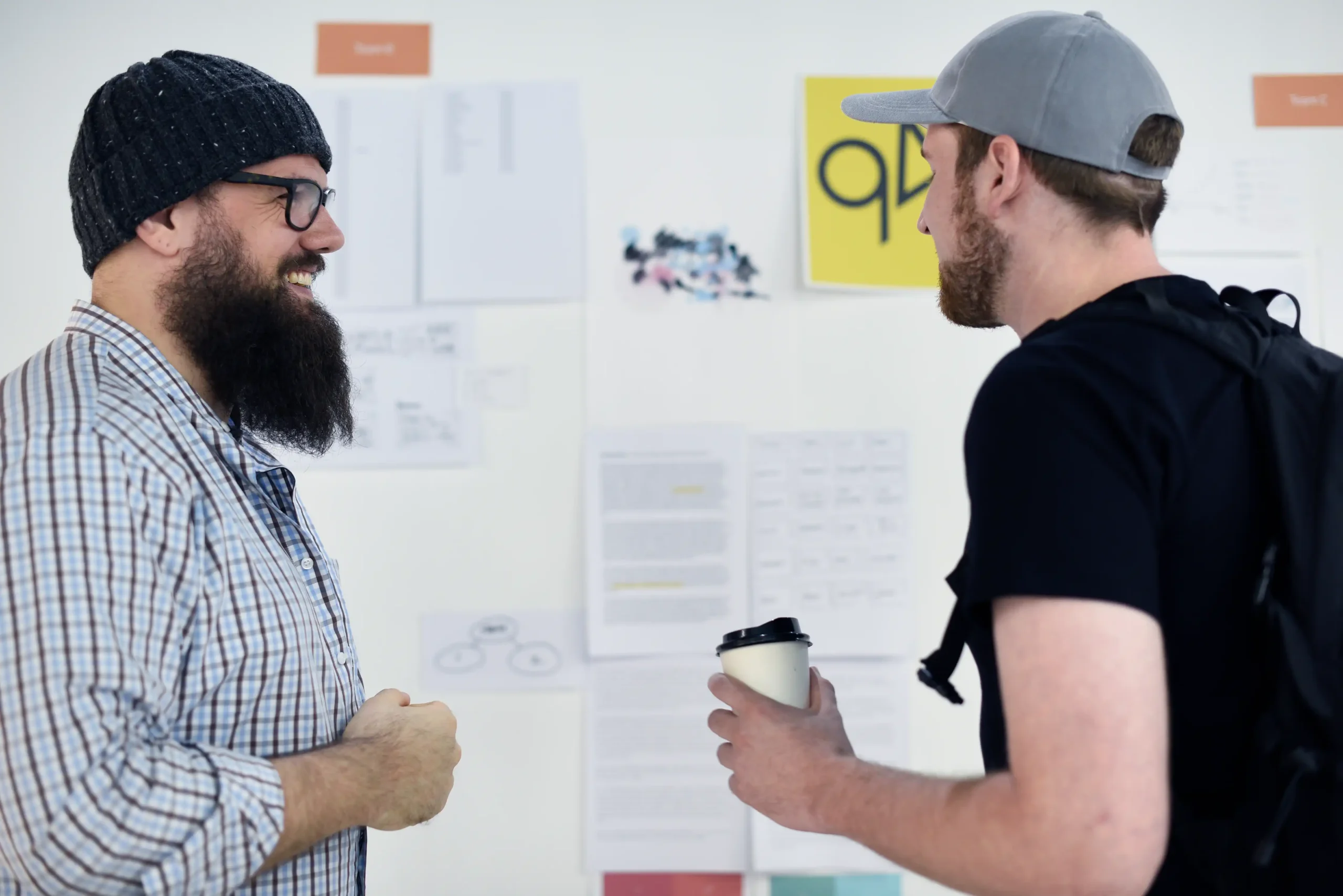 Two men talking in front of whiteboard on how they can grow their business. This is to show people a visual of how they can attack our Expert On Page Service.