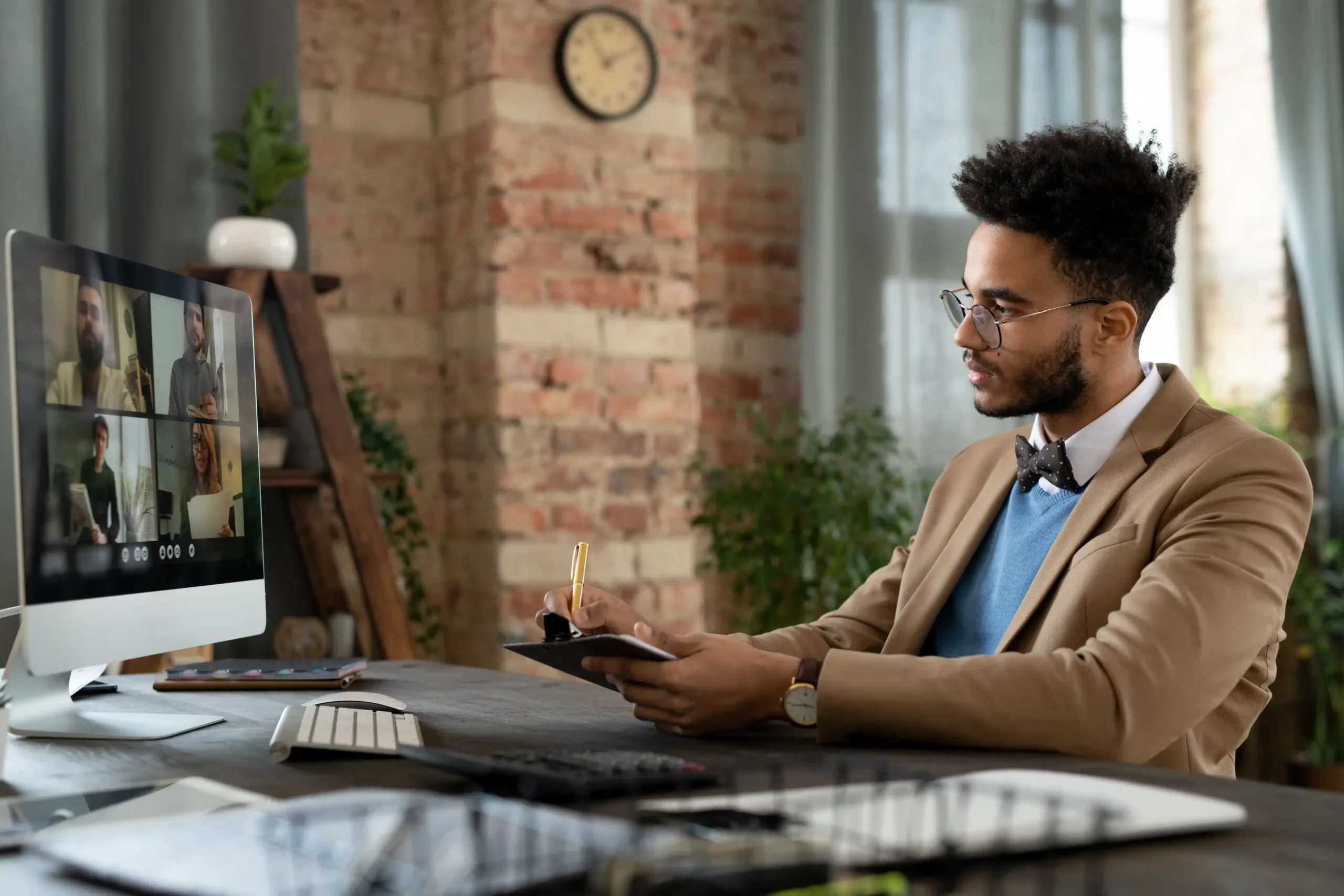 This is a brand owner taking notes from a consultant on his laptop. This is to visualize our Fashion SEO consulting services.
