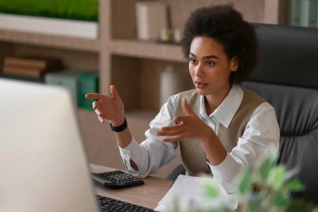 Black woman on a video call talking thorugh a webcam to a consultant. This is to show an example of our fashion SEO service.